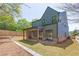 Exterior view of the backyard featuring a covered patio and lush green lawn at 504 Barrington Dr, Roswell, GA 30075