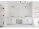 Bright bathroom featuring a double sink vanity with white cabinets, gold hardware, and a marble floor at 504 Barrington Dr, Roswell, GA 30075
