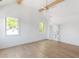 Bright bedroom with vaulted ceilings, wood beams, three large windows, and an ensuite bathroom at 504 Barrington Dr, Roswell, GA 30075