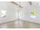 Bright bedroom with vaulted ceilings, wood beams, and three large windows providing lots of natural light at 504 Barrington Dr, Roswell, GA 30075