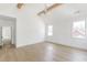 Bright bedroom with vaulted ceilings, wood beams, three large windows, and access to other rooms at 504 Barrington Dr, Roswell, GA 30075