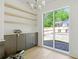 Bright dining area featuring custom cabinets, floating shelves, and sliding glass doors to a brick patio at 504 Barrington Dr, Roswell, GA 30075