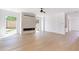 Open living room with hardwood flooring, stone fireplace, ample natural light, and backyard views at 504 Barrington Dr, Roswell, GA 30075