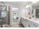 Bright bathroom features double vanity, tiled shower and view into the bedroom through an open doorway at 524 Provence Gate Ln, Lawrenceville, GA 30044