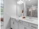 Contemporary bathroom featuring double sinks, white cabinets, and a view into a shower at 524 Provence Gate Ln, Lawrenceville, GA 30044