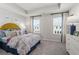 Cozy bedroom featuring a plush bed with a colorful floral pattern and modern furnishings at 524 Provence Gate Ln, Lawrenceville, GA 30044