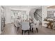 Dining area with a round table, gray chairs, and an open view into the modern kitchen space at 524 Provence Gate Ln, Lawrenceville, GA 30044