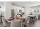 Bright dining area with stylish table and seating adjacent to a modern kitchen with stainless steel appliances at 524 Provence Gate Ln, Lawrenceville, GA 30044