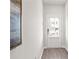 Welcoming hallway with hardwood floors, white walls, and door at 524 Provence Gate Ln, Lawrenceville, GA 30044