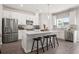 Well-lit kitchen featuring an island with seating, stainless steel appliances, and contemporary finishes at 524 Provence Gate Ln, Lawrenceville, GA 30044