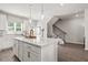 Bright kitchen with a large center island, pendant lighting, and easy access to the staircase at 524 Provence Gate Ln, Lawrenceville, GA 30044