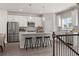 Bright kitchen boasts white cabinets, stainless steel appliances, and pendant lighting over the island at 524 Provence Gate Ln, Lawrenceville, GA 30044