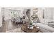Inviting living room showcasing open floor plan to the kitchen, wood floors, and comfortable seating at 524 Provence Gate Ln, Lawrenceville, GA 30044