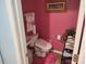 Compact bathroom featuring pink walls, bidet, and pedestal sink at 1074 Deshon Trl, Lithonia, GA 30058