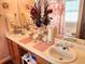 Bathroom featuring a large mirror reflecting double sinks, natural light, and pink mats and curtains at 1074 Deshon Trl, Lithonia, GA 30058