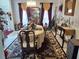 Dining area features a set table with elegant decor and a decorative chandelier, enhancing the room's ambiance at 1074 Deshon Trl, Lithonia, GA 30058