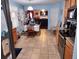 Eat-in kitchen features tiled flooring, wooden cabinets, granite countertops, and stainless steel appliances at 1074 Deshon Trl, Lithonia, GA 30058