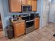 Kitchen featuring stainless steel microwave and oven, granite countertops, and wooden cabinetry at 1074 Deshon Trl, Lithonia, GA 30058