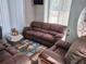 Comfortable seating area with reclining love seat, couch and natural light at 1074 Deshon Trl, Lithonia, GA 30058