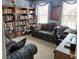 Office features a couch, bookshelves, computer desk, and large window for natural light in this comfortable working space at 1074 Deshon Trl, Lithonia, GA 30058