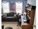 Comfortable office featuring a couch, desk, and computer setup for a productive work environment at 1074 Deshon Trl, Lithonia, GA 30058