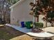 This property boasts a neat walkway, leading to a fenced backyard, with fresh gravel and tidy landscaping at 1074 Deshon Trl, Lithonia, GA 30058