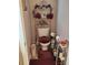 Cozy powder room featuring a toilet, decorative shelves, and a small sink for added convenience at 1074 Deshon Trl, Lithonia, GA 30058