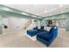 Finished basement with stairs, blue sectional, and view to pool table and game room at 2283 Edgemere Lake Cir, Marietta, GA 30062