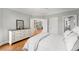 Bright bedroom featuring white dresser, hardwood floors, and view to living area at 2283 Edgemere Lake Cir, Marietta, GA 30062