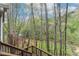Wood stairs lead to deck, surrounded by lush greenery, offering a tranquil view at 2283 Edgemere Lake Cir, Marietta, GA 30062