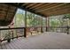 Spacious wooden deck with wooden ceiling and railings, featuring two lounge chairs at 2283 Edgemere Lake Cir, Marietta, GA 30062