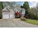 Charming two-story home with a two-car garage, beautiful landscaping, and a well-manicured lawn at 2283 Edgemere Lake Cir, Marietta, GA 30062