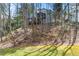 View of home nestled among trees showing decks at 2283 Edgemere Lake Cir, Marietta, GA 30062