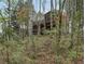 Exterior of home nestled among trees showing screened porch at 2283 Edgemere Lake Cir, Marietta, GA 30062
