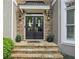 Elegant front door with stone surround, decorative wreaths, and covered entryway at 2283 Edgemere Lake Cir, Marietta, GA 30062