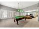 Game room with pool table, three pendant lights, and adjacent living area at 2283 Edgemere Lake Cir, Marietta, GA 30062