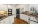 The modern kitchen features stainless steel appliances, granite countertops, and a stylish backsplash at 2283 Edgemere Lake Cir, Marietta, GA 30062