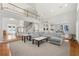 Open-concept living room with soaring ceilings, staircase, and modern furnishings at 2283 Edgemere Lake Cir, Marietta, GA 30062