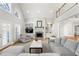 Bright living room with a fireplace, built-in shelving, and shuttered doors at 2283 Edgemere Lake Cir, Marietta, GA 30062