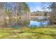 Scenic pond with two benches surrounded by green grass and trees at 2283 Edgemere Lake Cir, Marietta, GA 30062