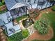 Aerial shot showcasing the backyard with a deck, screened-in porch, pond, and lush landscaping at 29 Fern Leaf Ct, Dallas, GA 30157