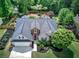 An aerial view showcases the charming home with a manicured lawn, fenced backyard, and well-maintained landscaping at 29 Fern Leaf Ct, Dallas, GA 30157