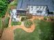 Aerial view of a backyard with a deck, pond, landscaping, and grassy area at 29 Fern Leaf Ct, Dallas, GA 30157