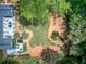Aerial view of a spacious backyard with a deck, pond, landscaping, and mature trees at 29 Fern Leaf Ct, Dallas, GA 30157