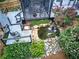 Landscaped backyard showcasing a serene pond, waterfall feature, deck, screened in porch and lush greenery at 29 Fern Leaf Ct, Dallas, GA 30157