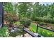 Landscaped backyard features a charming water feature and lush plantings to create a tranquil outdoor space at 29 Fern Leaf Ct, Dallas, GA 30157