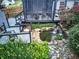 Backyard features a charming pond with waterfall, deck, screened porch, and delightful landscaping and plantings at 29 Fern Leaf Ct, Dallas, GA 30157