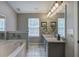 Bright bathroom features a double sink vanity with granite countertop at 29 Fern Leaf Ct, Dallas, GA 30157
