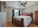 Cozy bedroom features a comfortable bed, neutral paint, ceiling fan, and natural light at 29 Fern Leaf Ct, Dallas, GA 30157