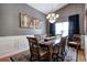 Formal dining room with a large wooden table, decorative rug, and elegant chandelier at 29 Fern Leaf Ct, Dallas, GA 30157